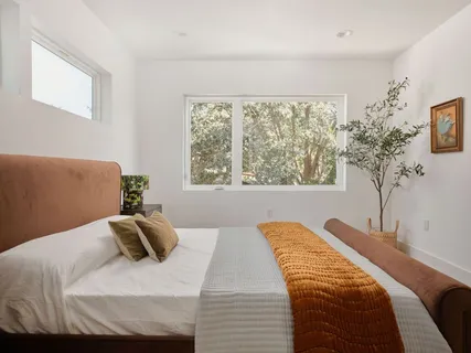 a bedroom with a bed and a window