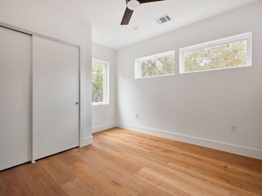 3307 Kay Street, Unit 1 Austin, TX 78702 - Photo 29 of 40 a view of an empty room with wooden floor and a window