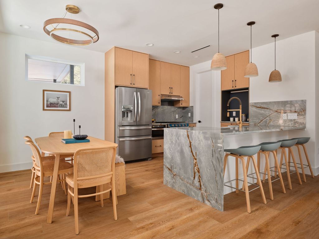 3307 Kay Street, Unit 1 Austin, TX 78702 - Photo 5 of 40 a kitchen with stainless steel appliances granite countertop a kitchen island a stove a table and chairs