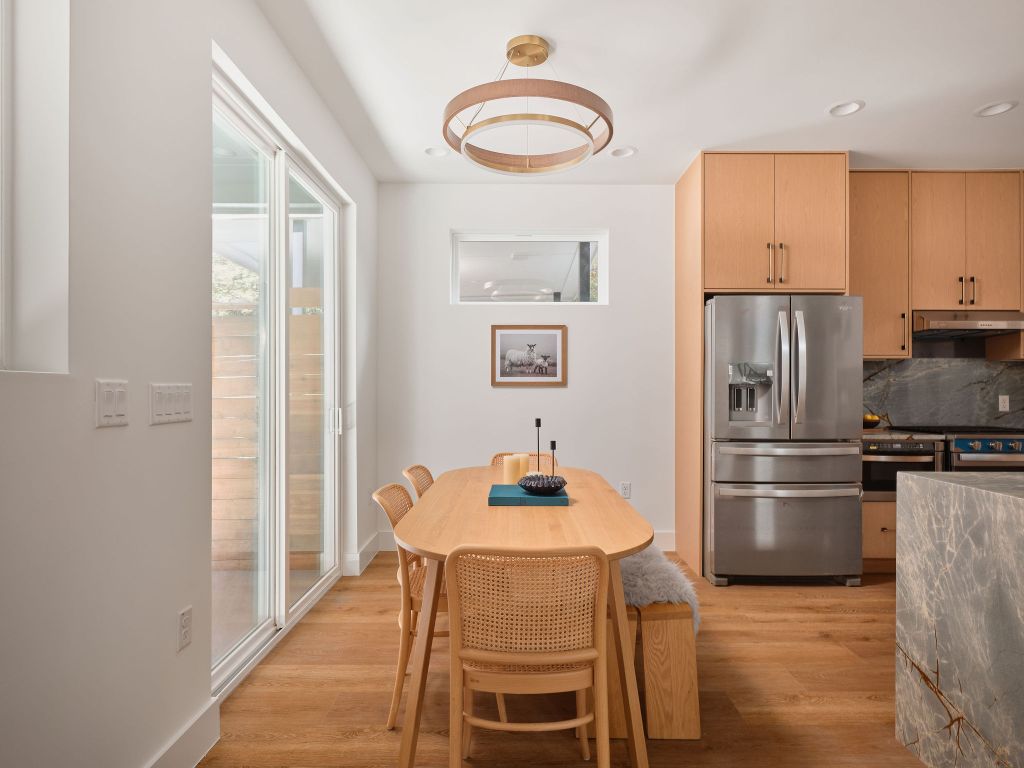 3307 Kay Street, Unit 1 Austin, TX 78702 - Photo 7 of 40 a kitchen with stainless steel appliances a refrigerator a stove a dining table and chairs