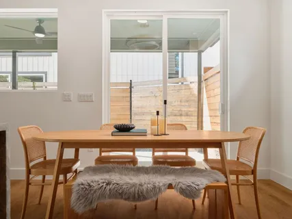 a view of a dining room with furniture and a window