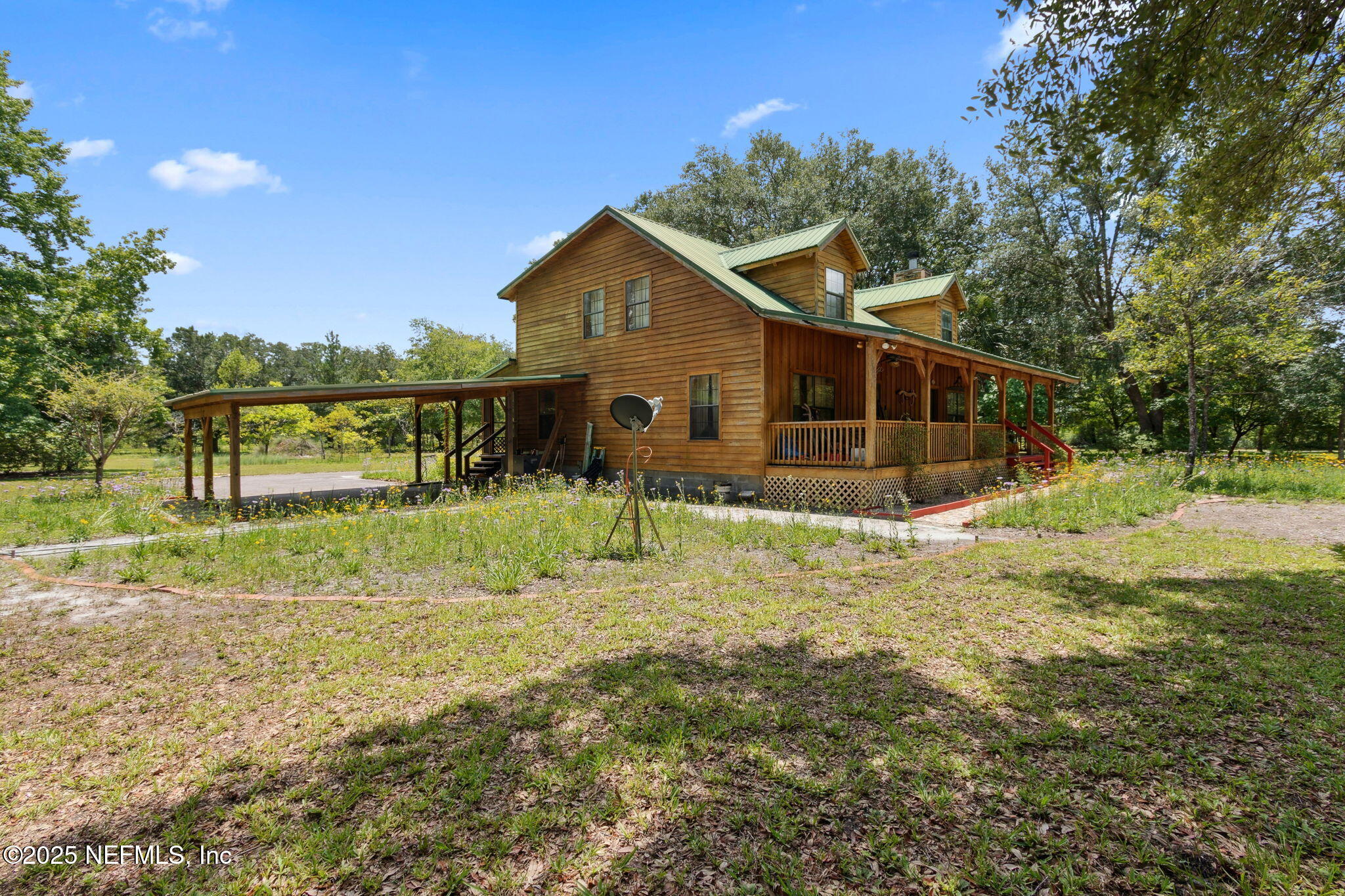 a view of a house with yard and sitting area