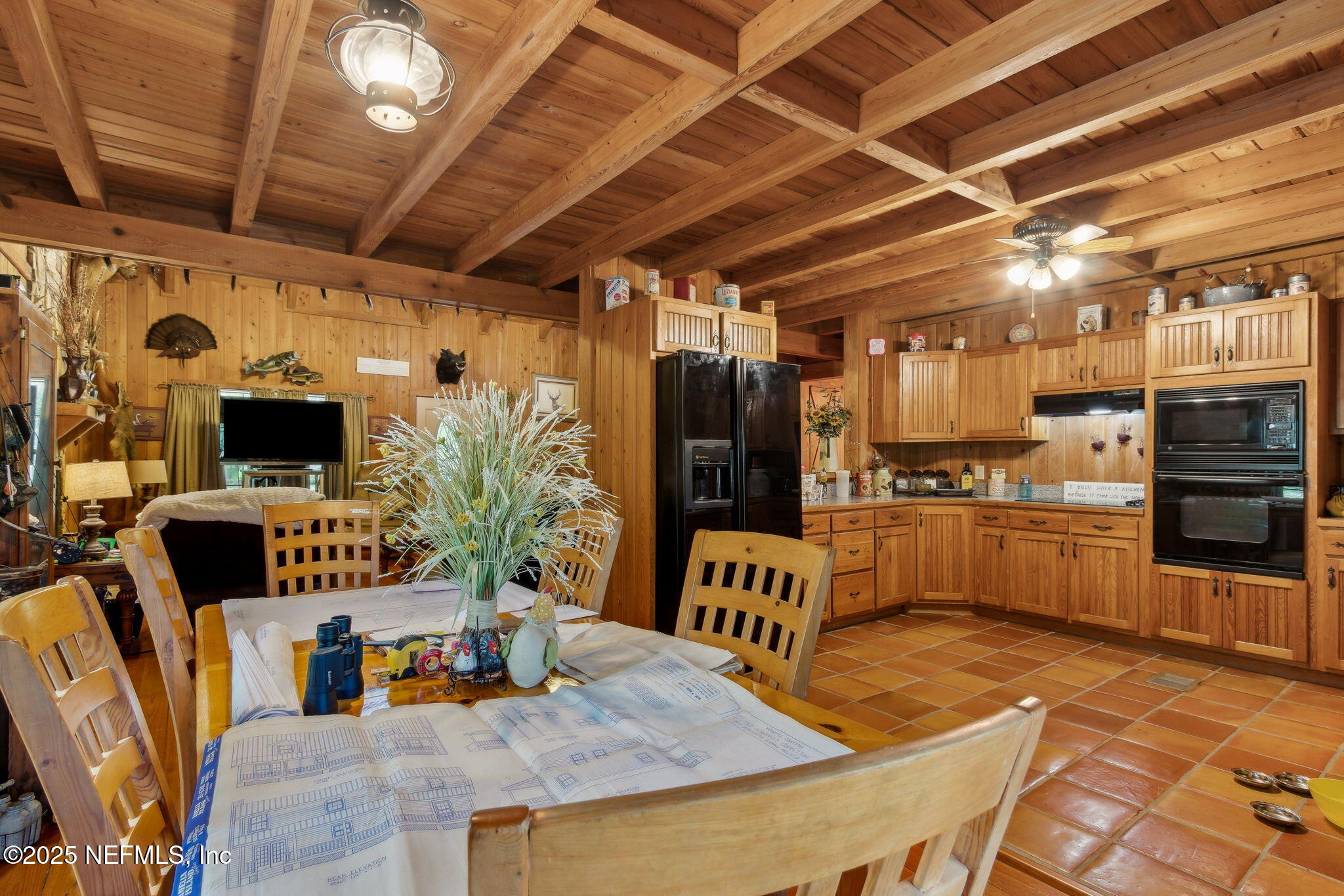 37334 Alice Street Hilliard, FL 32046 - Photo 20 of 80 a kitchen with stainless steel appliances kitchen island granite countertop a table chairs in it and a wooden floor