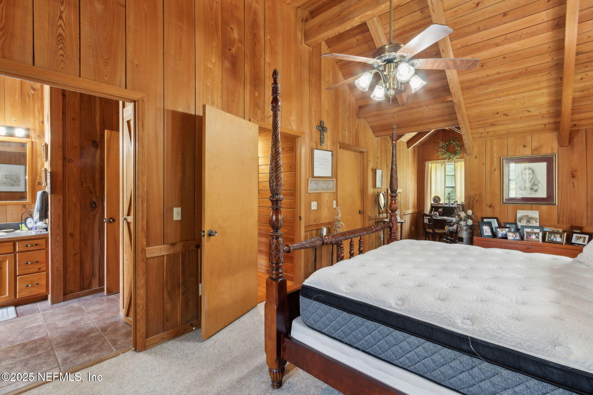 37334 Alice Street Hilliard, FL 32046 - Photo 27 of 80 a bedroom with a bed a table and potted plants