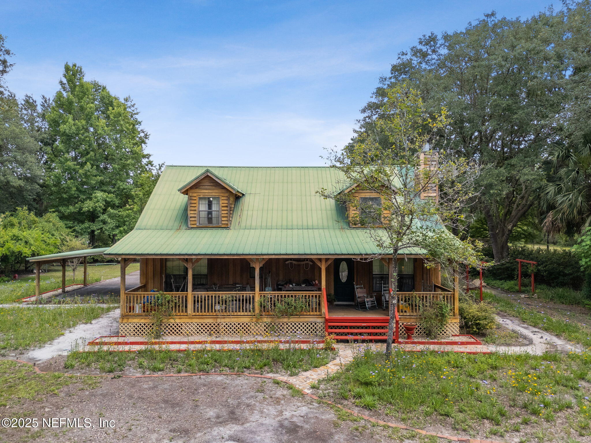 37334 Alice Street Hilliard, FL 32046 - Photo 63 of 80 a front view of a house with a yard table and chairs