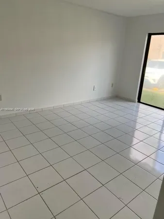 a view of an empty room and wooden floor