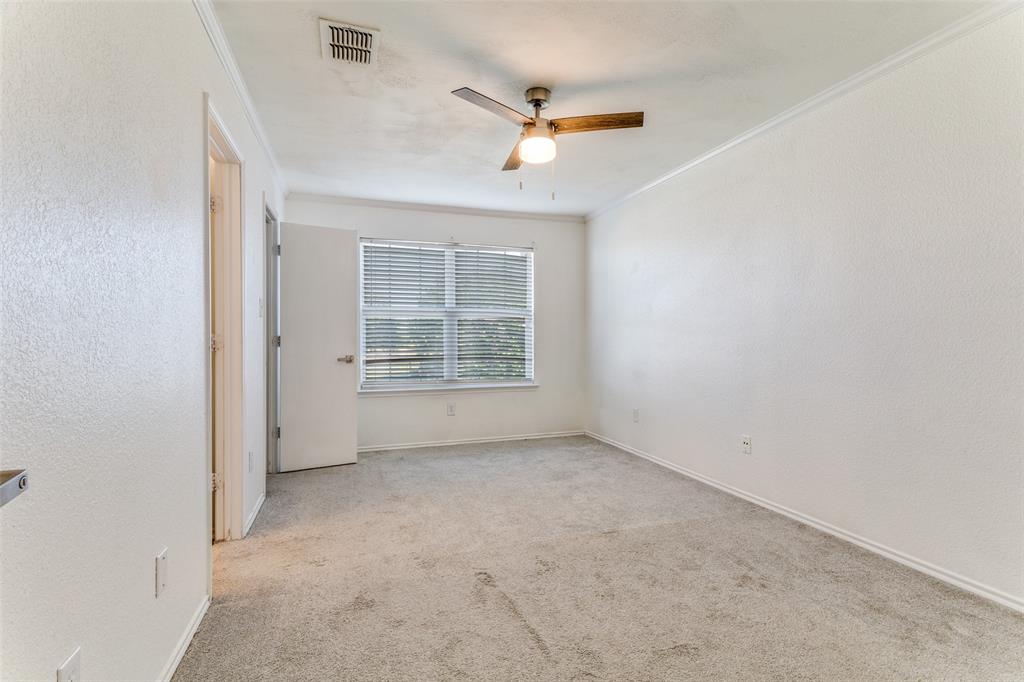 5616 Giddyup Lane Fort Worth, TX 76179 - Photo 14 of 28 Empty room featuring crown molding, light colored carpet, ceiling fan, and a textured wall