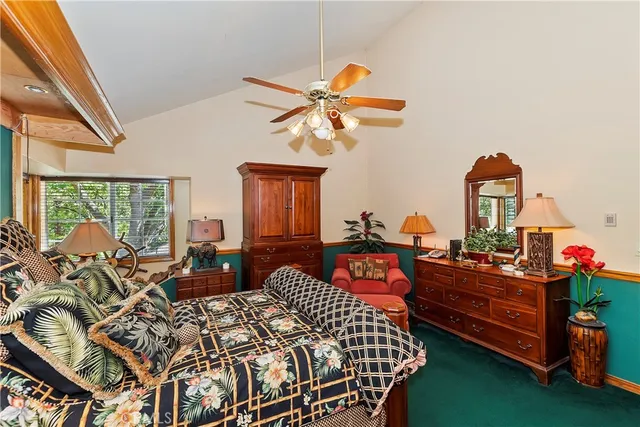 a bedroom with furniture and large windows