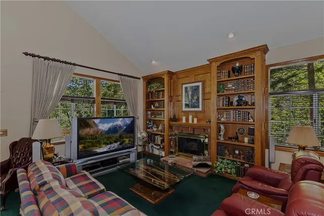 a living room with fireplace furniture and a flat screen tv
