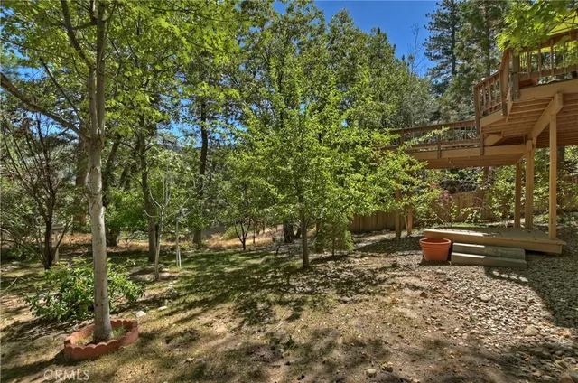 an aerial view of ocean with green space