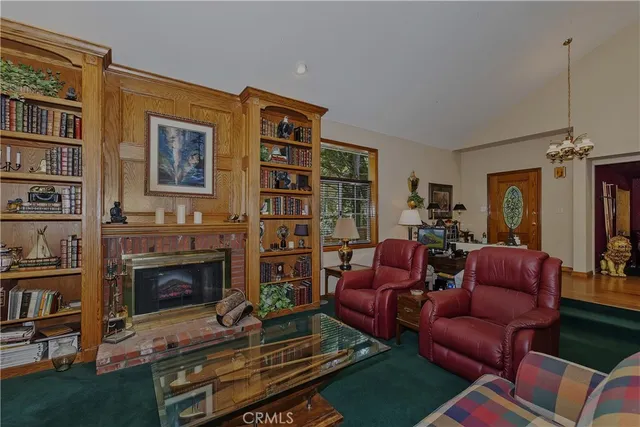 a living room with furniture a bookshelf and a fireplace