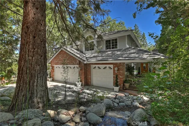 a aerial view of a houses with a lush green hillside