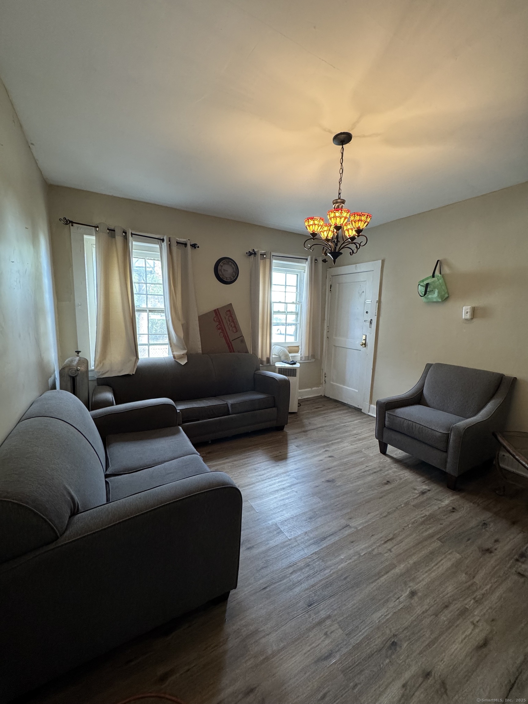 785 Connecticut Avenue, Unit 2 Bridgeport, CT 06607 - Photo 3 of 9 a living room with furniture and a chandelier