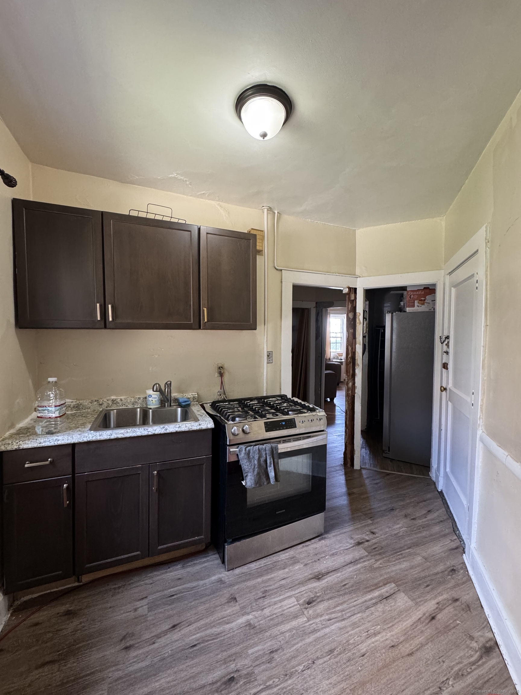 785 Connecticut Avenue, Unit 2 Bridgeport, CT 06607 - Photo 8 of 9 a kitchen with stainless steel appliances granite countertop a stove and a sink