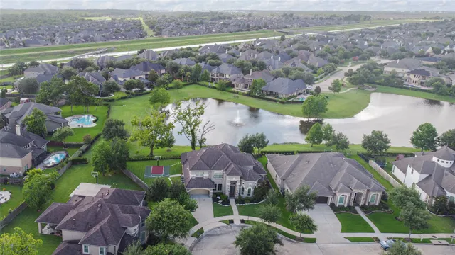 an aerial view of a house with a garden and lake view