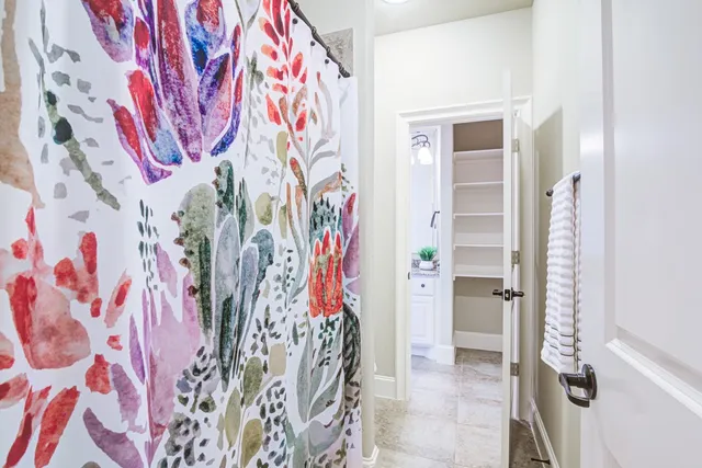 a bathroom with a bathtub and shower curtain