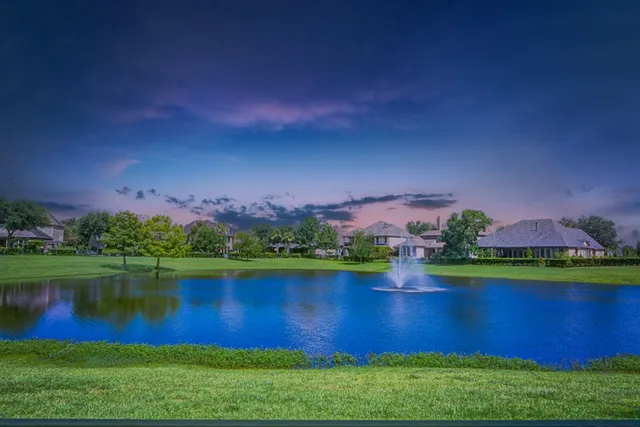 a view of a lake with houses in the back