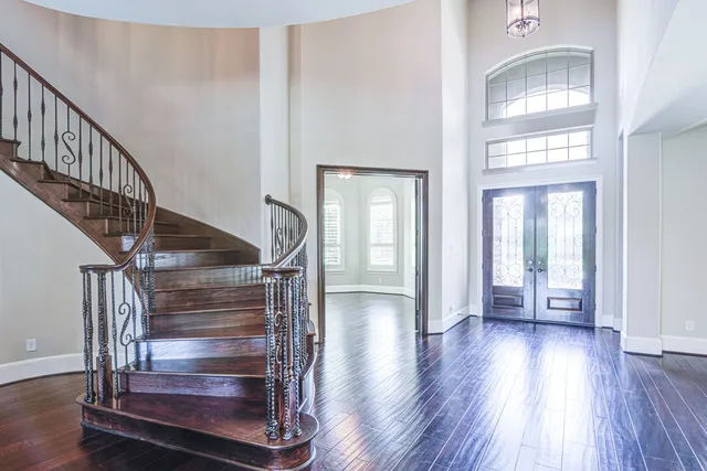 a view of entryway and hall with wooden floor