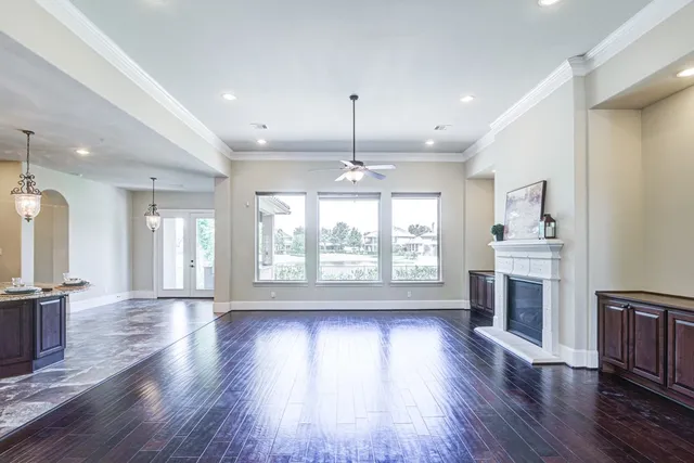 an empty room with wooden floor and outdoor view