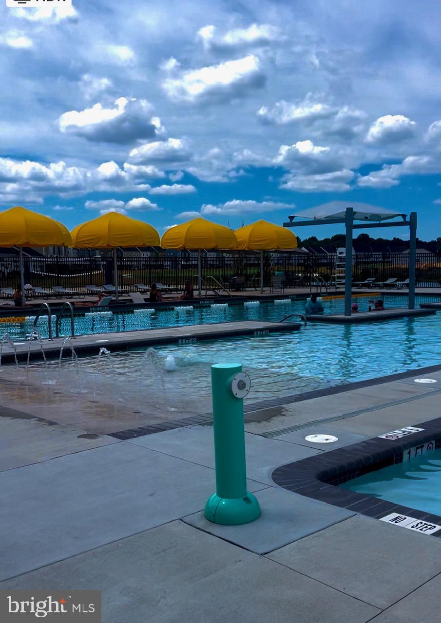 35262 Wright Way Millsboro, DE 19966 - Photo 38 of 42 a view of swimming pool with a table and chairs
