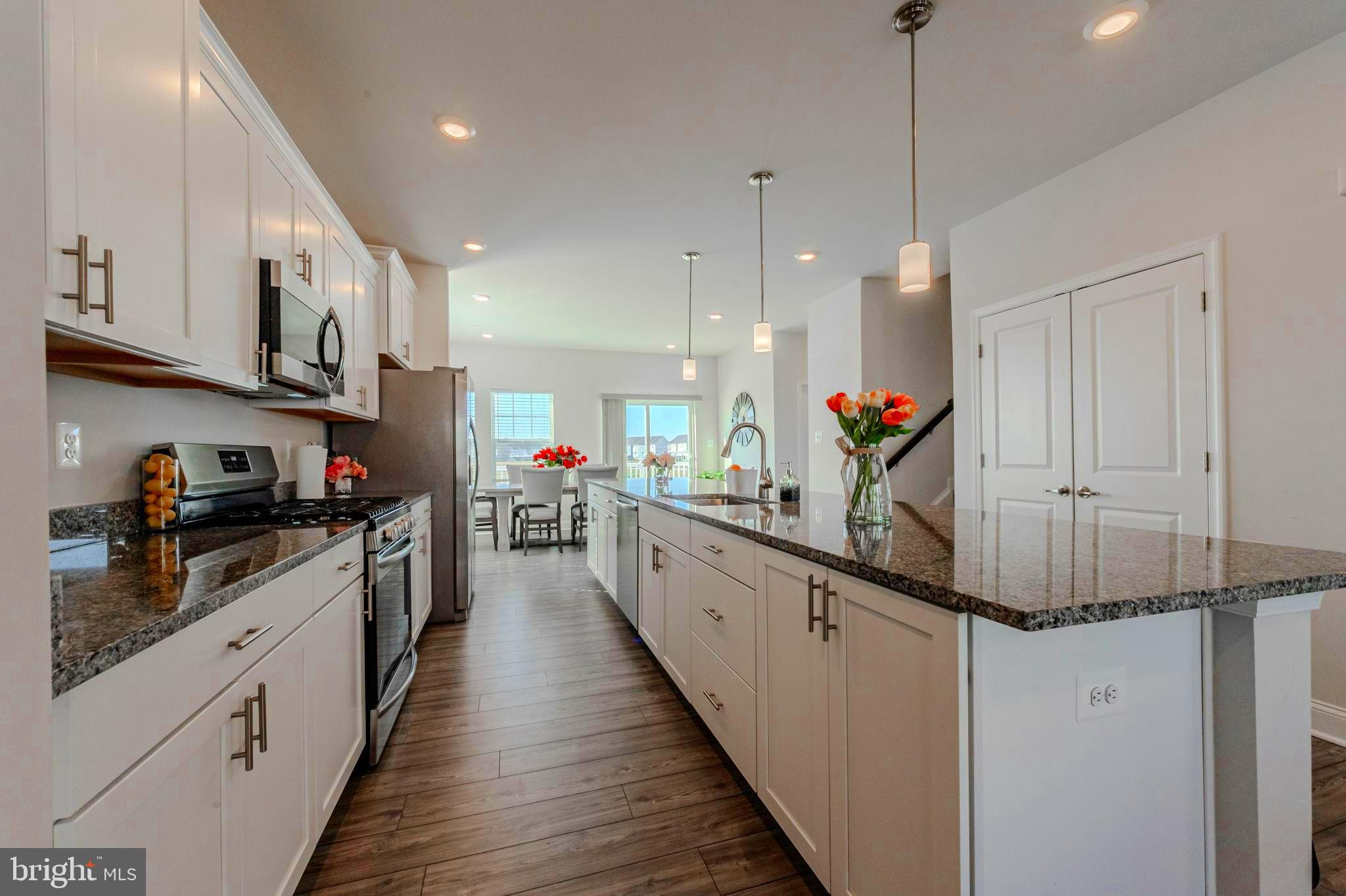 35262 Wright Way Millsboro, DE 19966 - Photo 6 of 42 a kitchen with stainless steel appliances kitchen island granite countertop a sink and cabinets