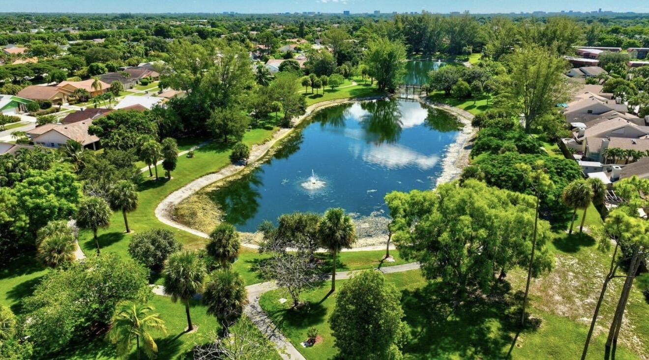 7745 Stanway Place Boca Raton, FL 33433 - Photo 7 of 7 an aerial view of residential houses with outdoor space and trees all around