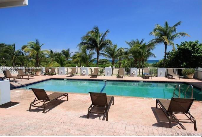 9341 Collins Avenue, Unit 806 Surfside, FL 33154 - Photo 2 of 27 a view of a swimming pool and lounge chair
