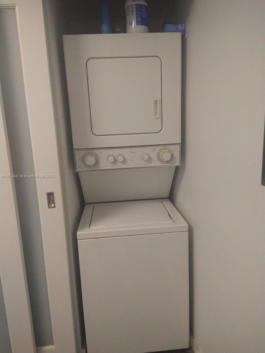 9341 Collins Avenue, Unit 806 Surfside, FL 33154 - Photo 22 of 27 a utility room with dryer and washer