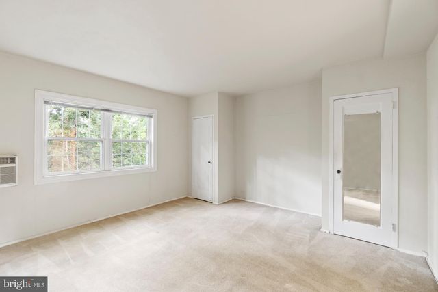a view of an empty room and closet area
