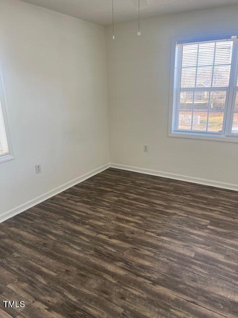 2011 Wolfmill Drive, Unit 203 Raleigh, NC 27603 - Photo 8 of 11 an empty room with wooden floor and windows
