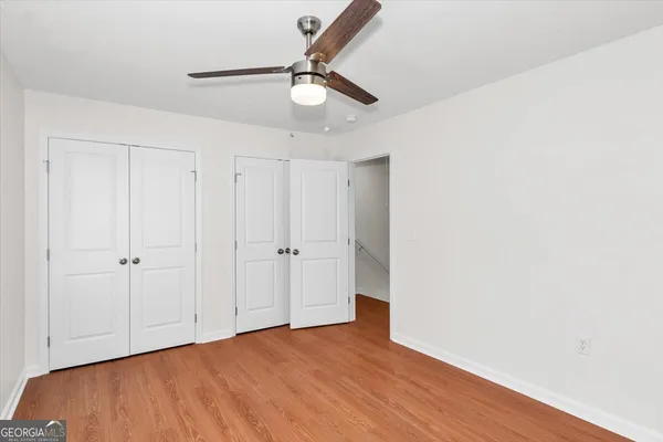 a view of an empty room with wooden floor