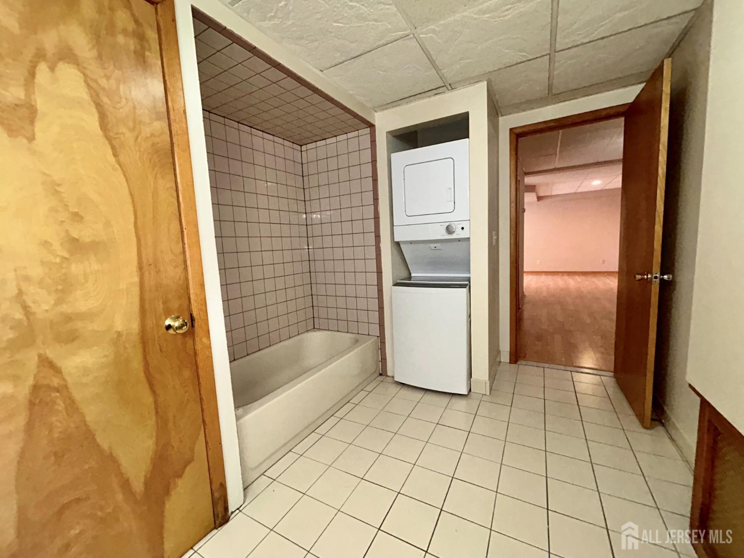 54 Loring Avenue, Unit 1 Edison, NJ 08817 - Photo 15 of 16 a bathroom with a bathtub and shower