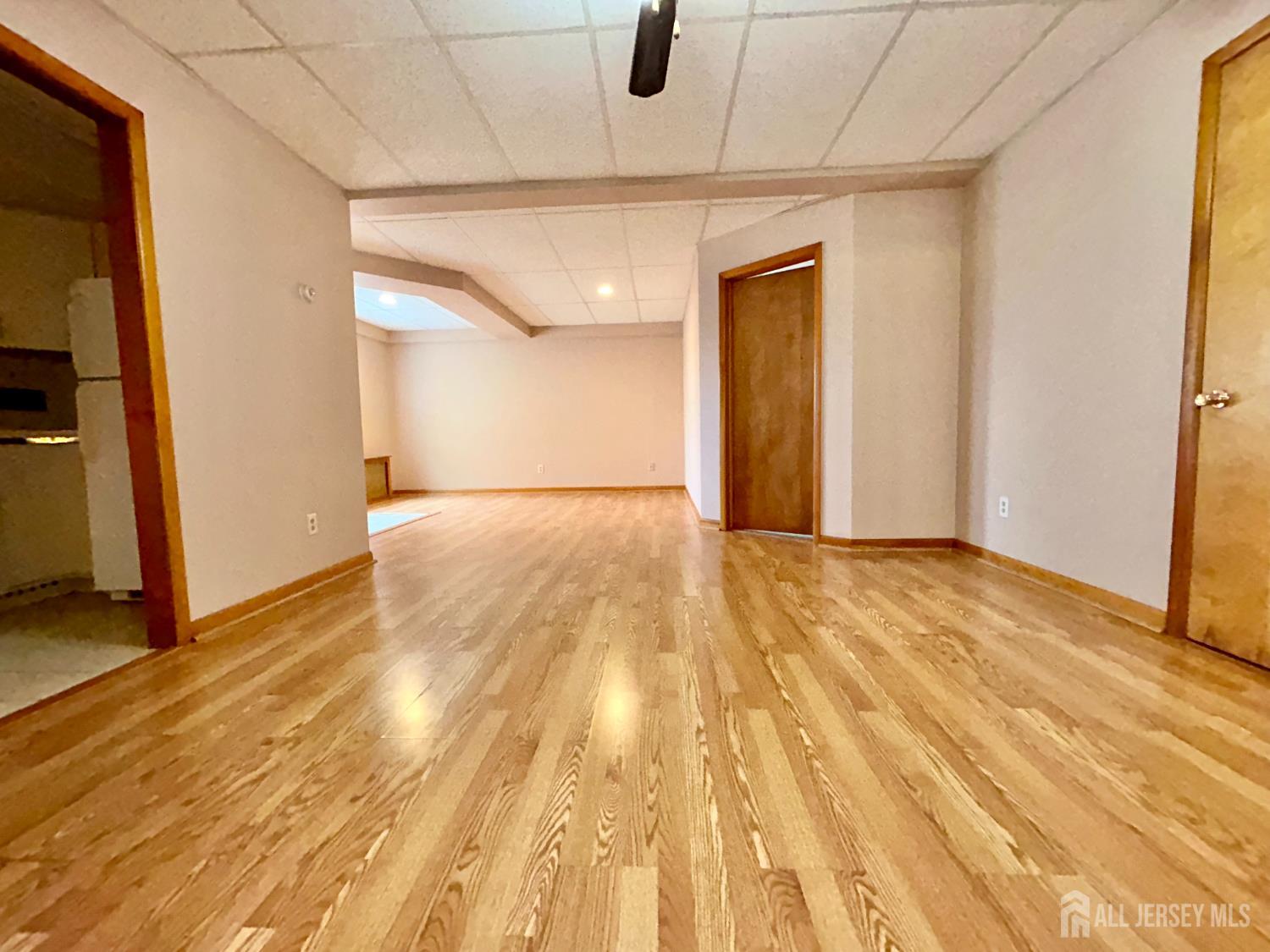 54 Loring Avenue, Unit 1 Edison, NJ 08817 - Photo 4 of 16 a view of an empty room with wooden floor