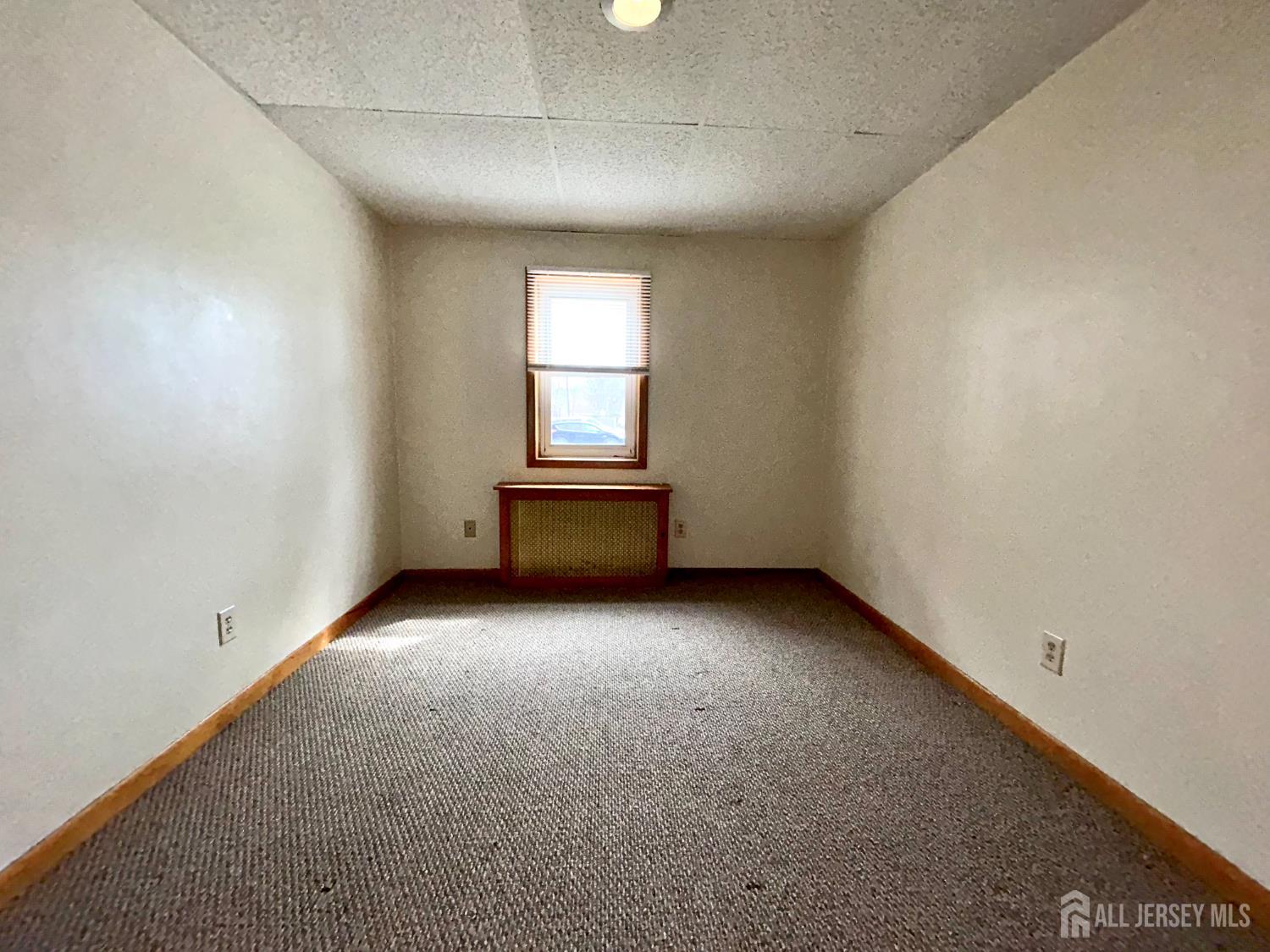 54 Loring Avenue, Unit 1 Edison, NJ 08817 - Photo 10 of 16 an empty room with a window
