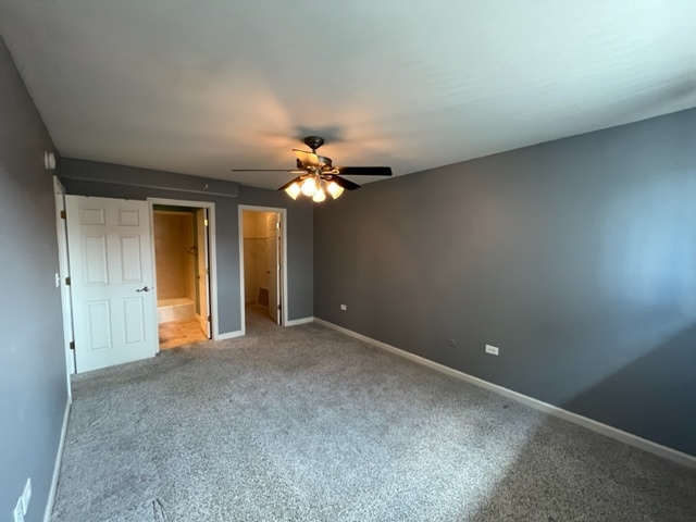 1919 South Wolf Road, Unit 416 Hillside, IL 60162 - Photo 16 of 24 a view of an empty room with a chandelier fan