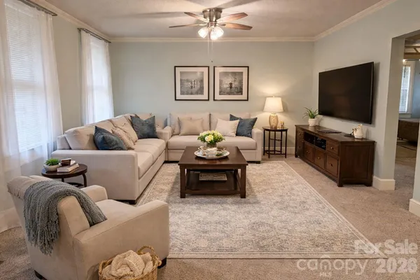 a living room with furniture and a flat screen tv