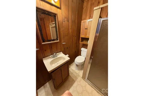 a bathroom with a sink toilet and mirror