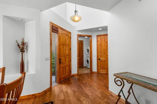 a view of an entryway with wooden floor