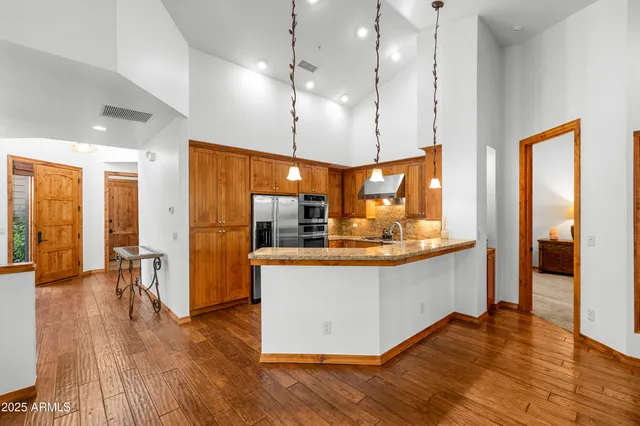 an open kitchen with a sink and refrigerator