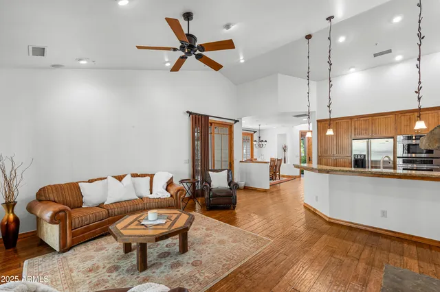 a living room with furniture and a wooden floor