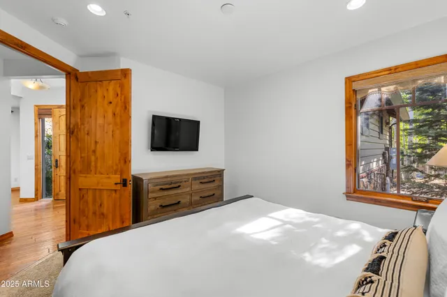 a bedroom with a bed and a flat screen tv