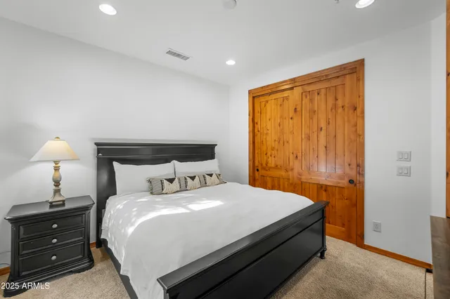 a bedroom with a bed and a lamp