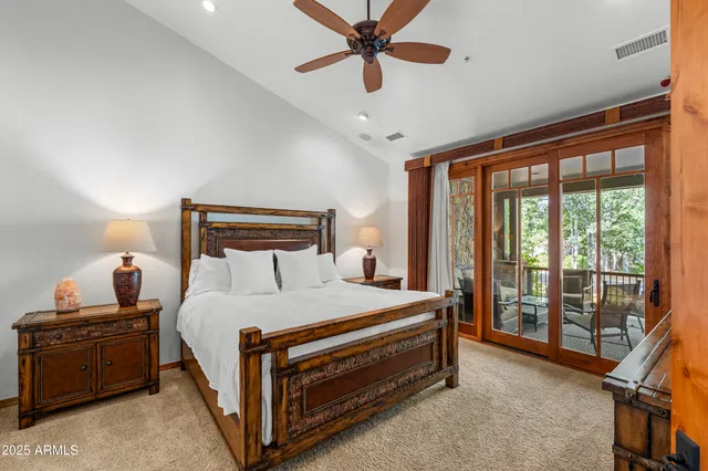 a bedroom with a bed and a ceiling fan
