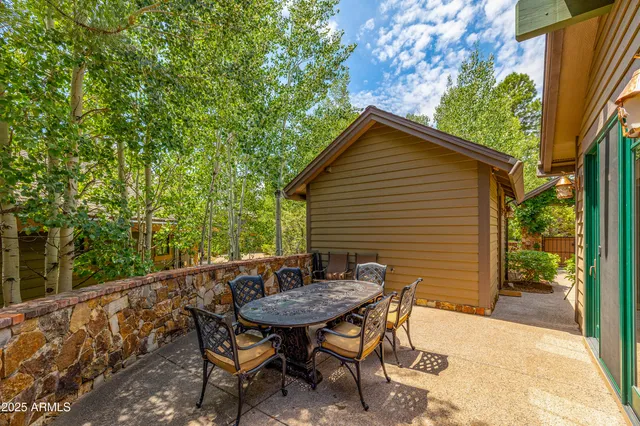 a backyard of a house with table and chairs