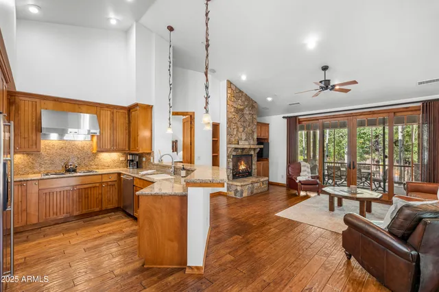 a large kitchen with kitchen island a large window in it