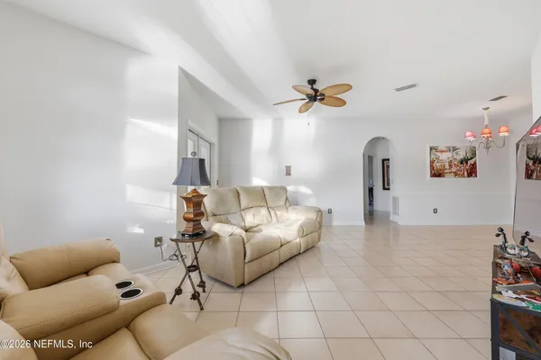 a living room with furniture and a chandelier