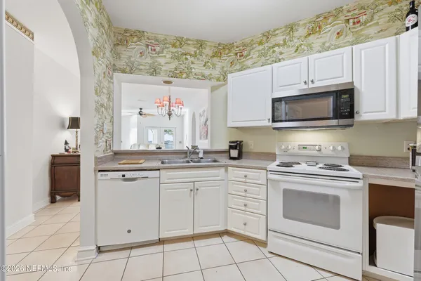 a kitchen with cabinets stainless steel appliances and a sink