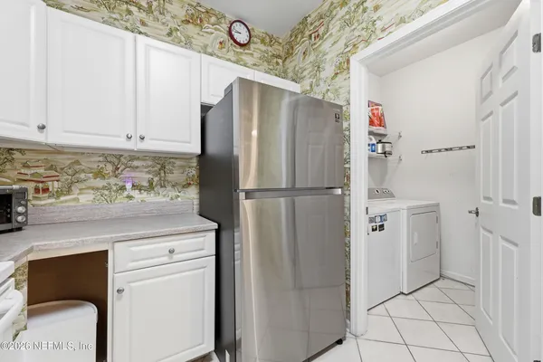 a kitchen with stainless steel appliances a refrigerator and cabinets