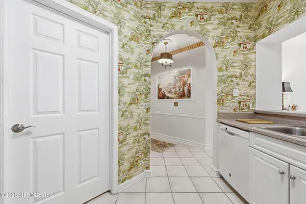 a bathroom with a granite countertop sink a toilet and a window