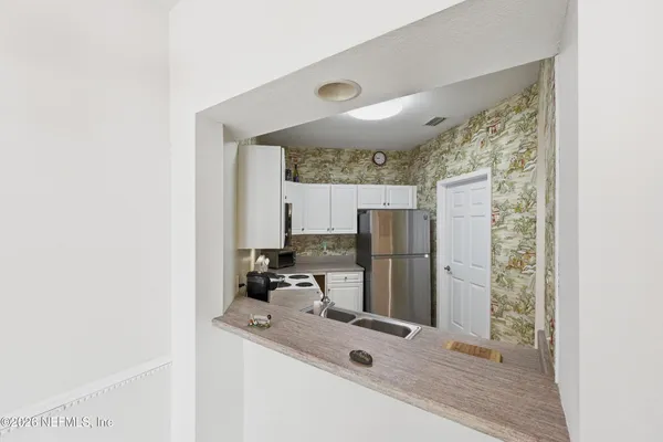 a kitchen with refrigerator and window